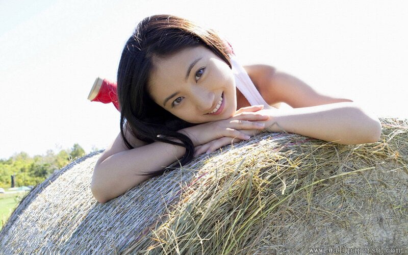 woman resting on hay bale