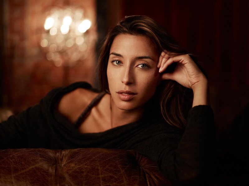 woman resting on leather couch