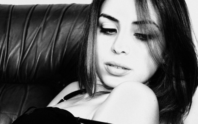 woman resting on leather couch