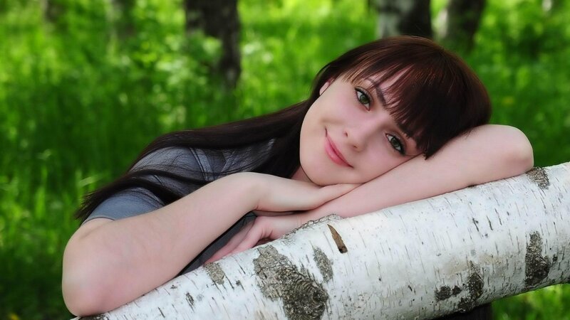 Woman Resting on Log