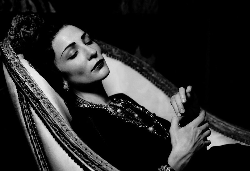 woman resting on ornate chair