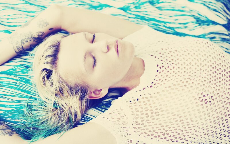 woman resting on patterned bed