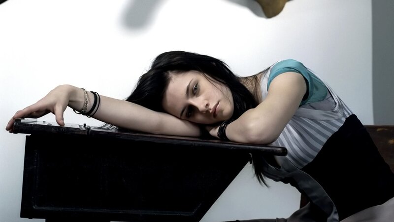 woman resting on piano