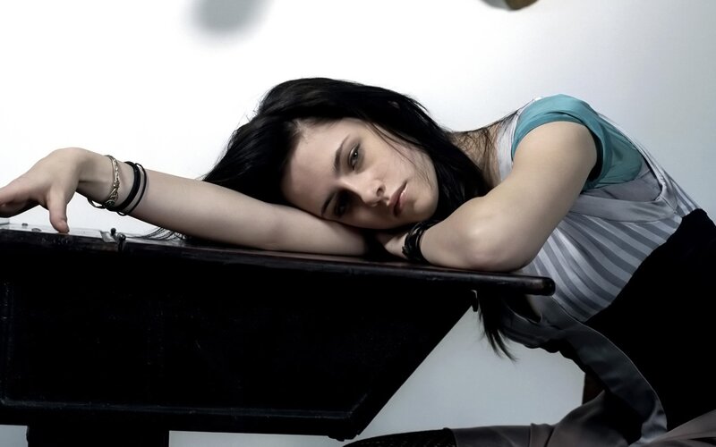 woman resting on piano