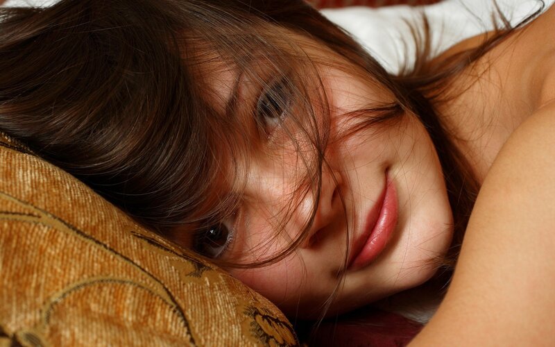 woman resting on pillow