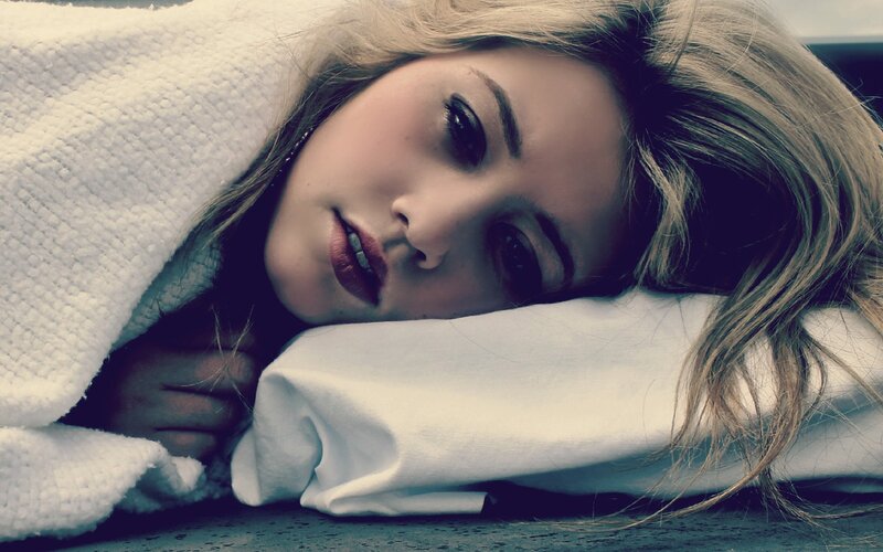 woman resting on pillow