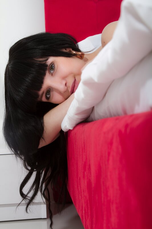 woman resting on red bed