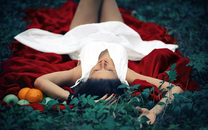 Woman resting on red cloth