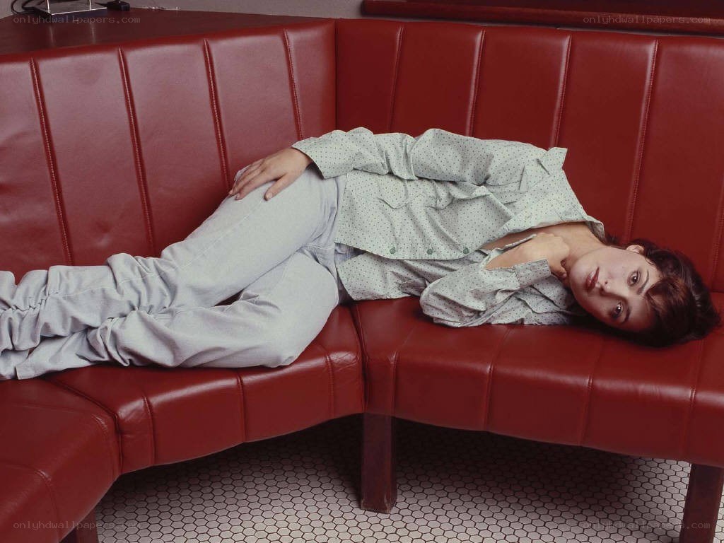 Woman resting on red couch
