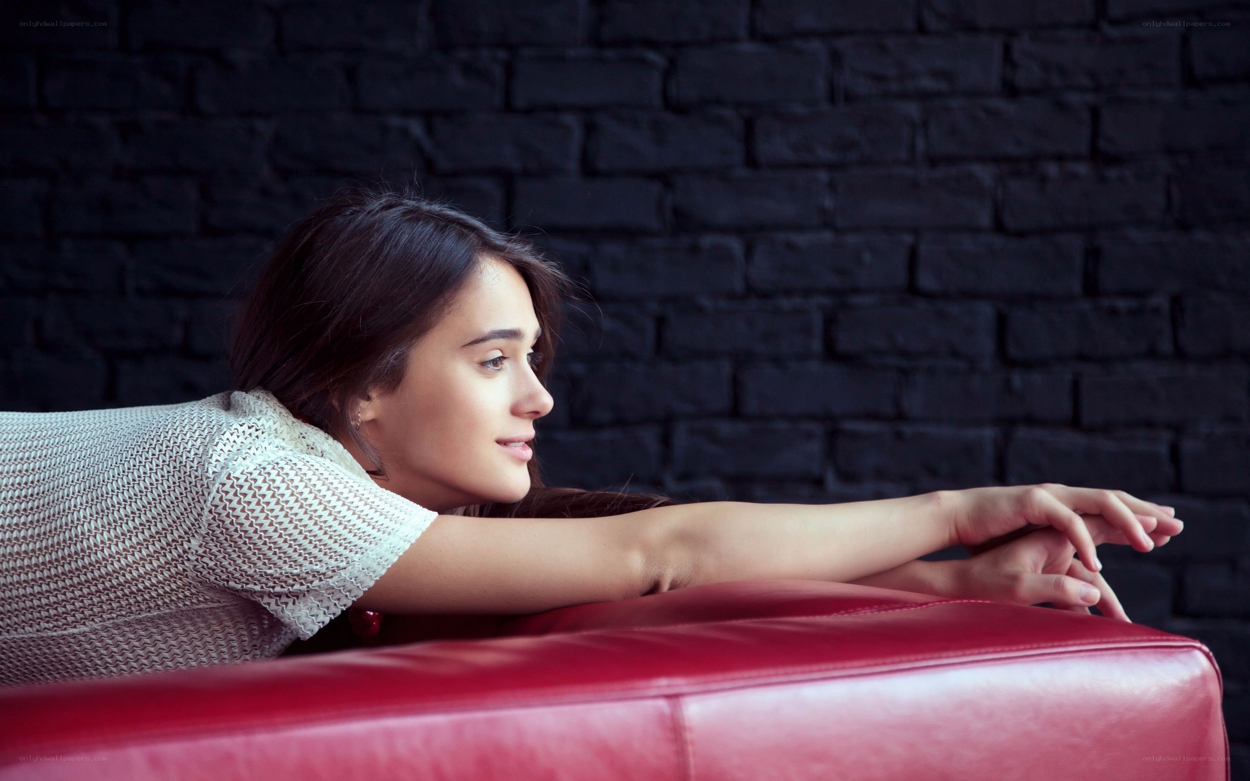 woman resting on red couch