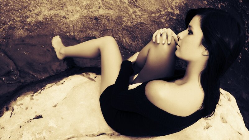woman resting on rock