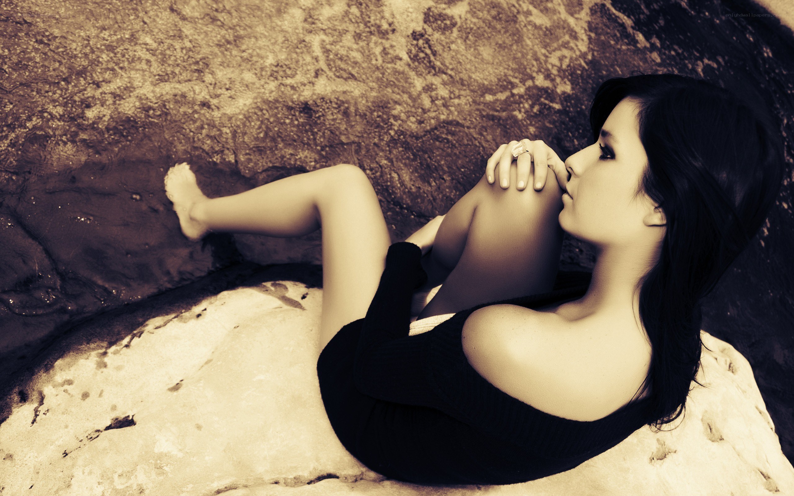 woman resting on rocks