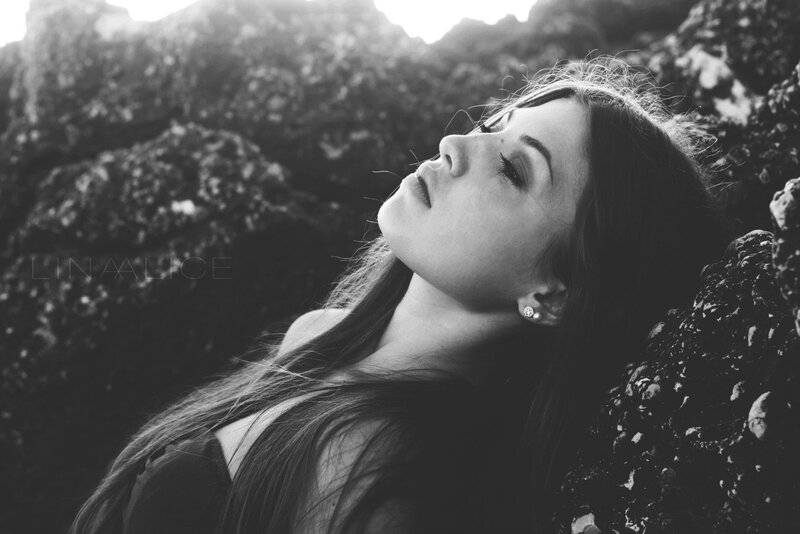 woman resting on rocks