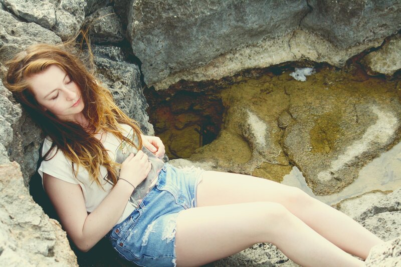Woman Resting on Rocks — Blue