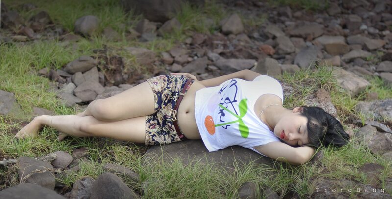 Woman resting on rocky ground