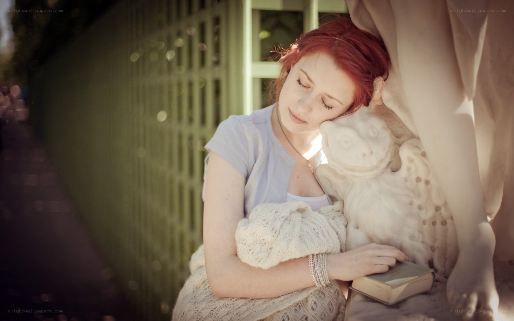 woman resting on statue
