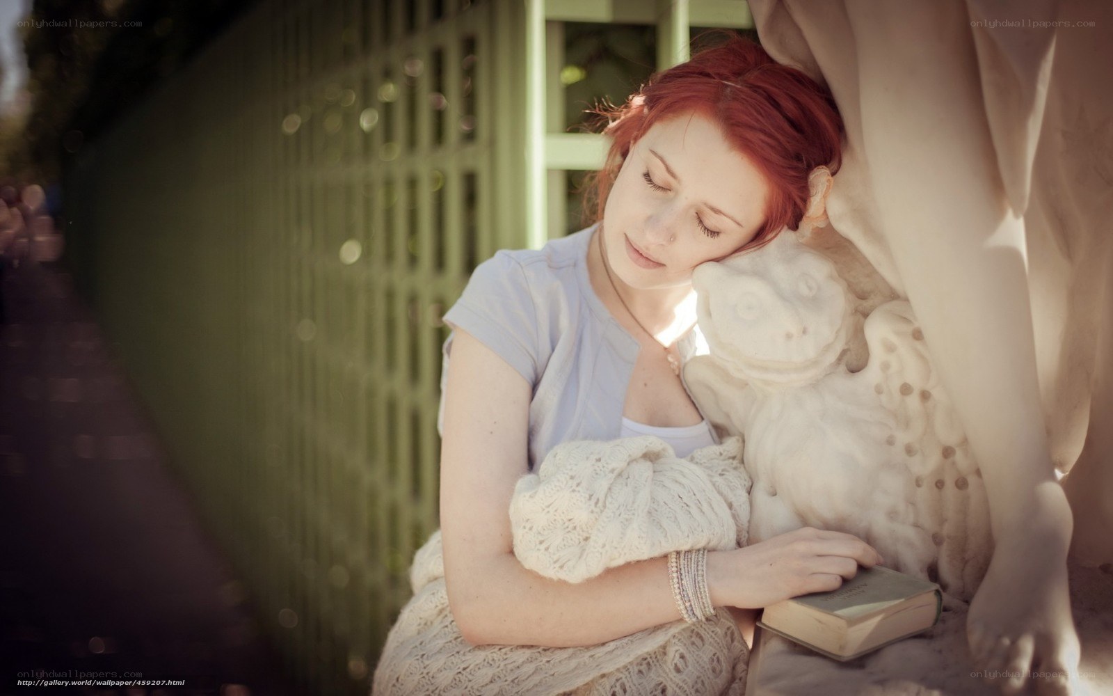 Woman resting on statue