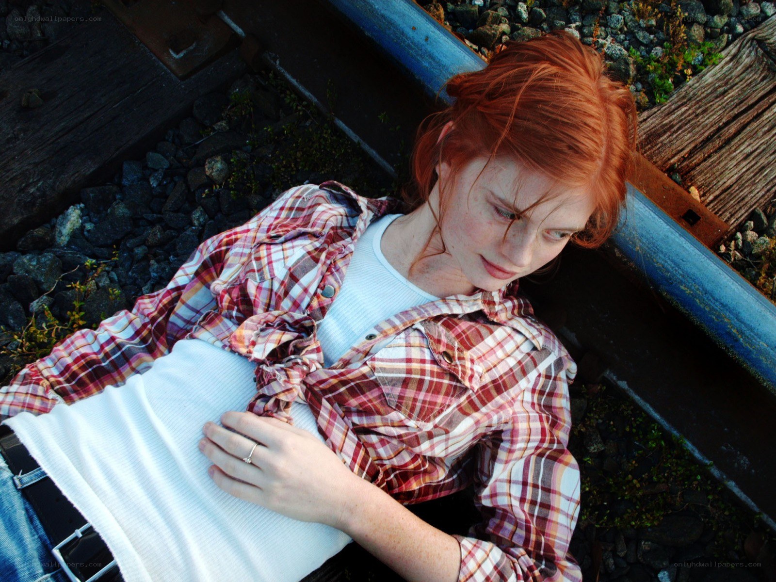 Woman resting on train tracks