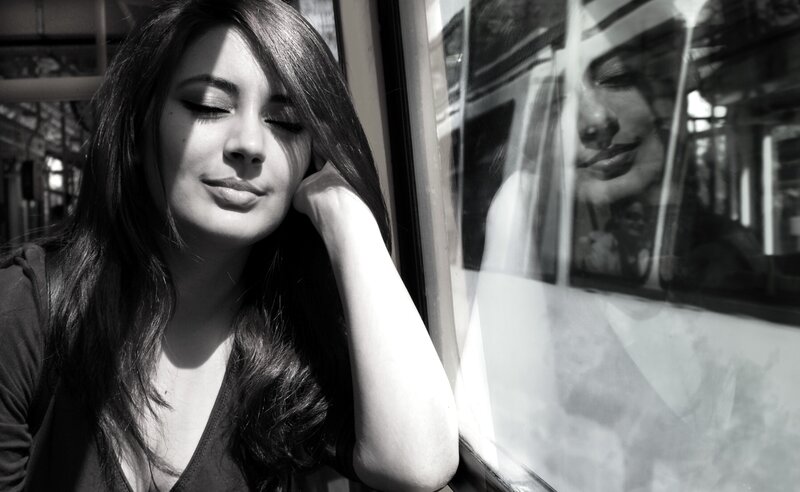 woman resting on train window