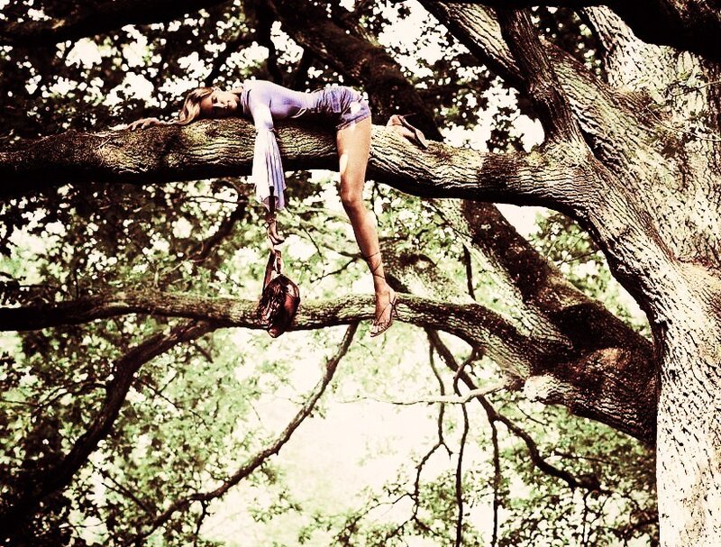 woman resting on tree branch