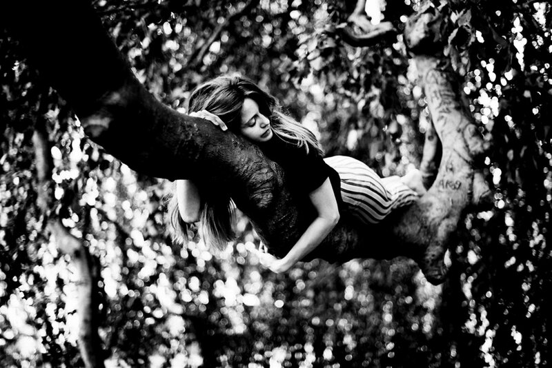 Woman Resting on Tree Branch — Black