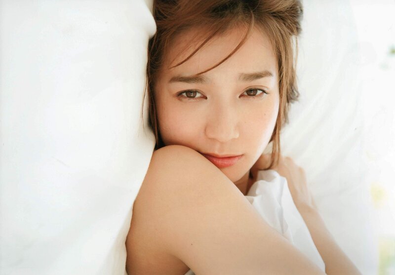 woman resting on white pillow