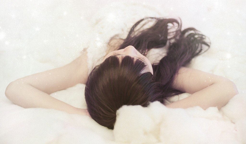 woman resting on white surface