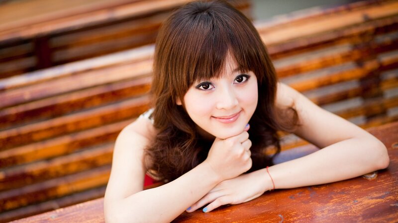 woman resting on wooden bench