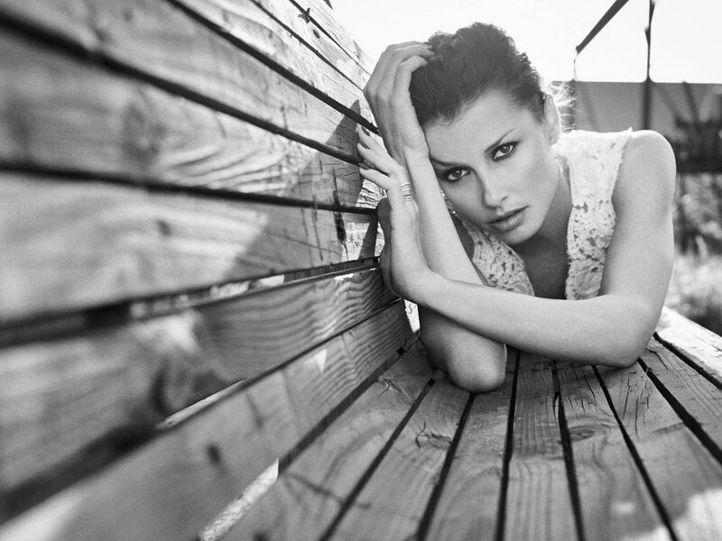 woman resting on wooden bench