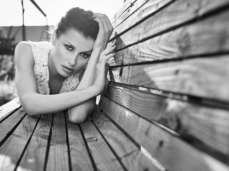woman resting on wooden bench