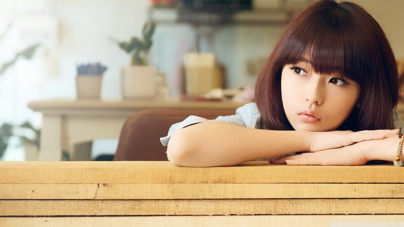 woman resting on wooden table