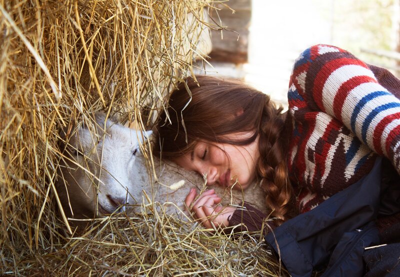 Woman resting with a lamb