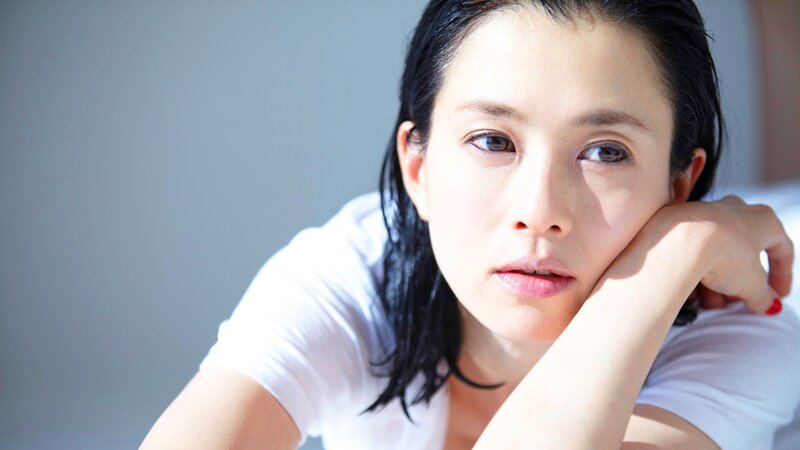 woman resting with hand on cheek