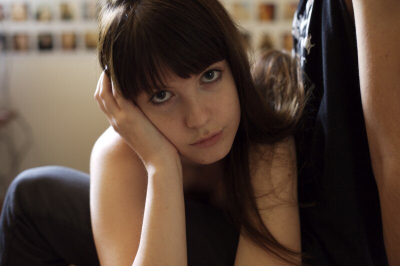 woman resting with hand on face