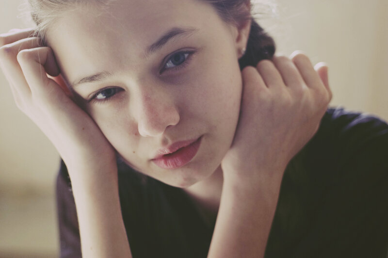 woman resting with hands on face