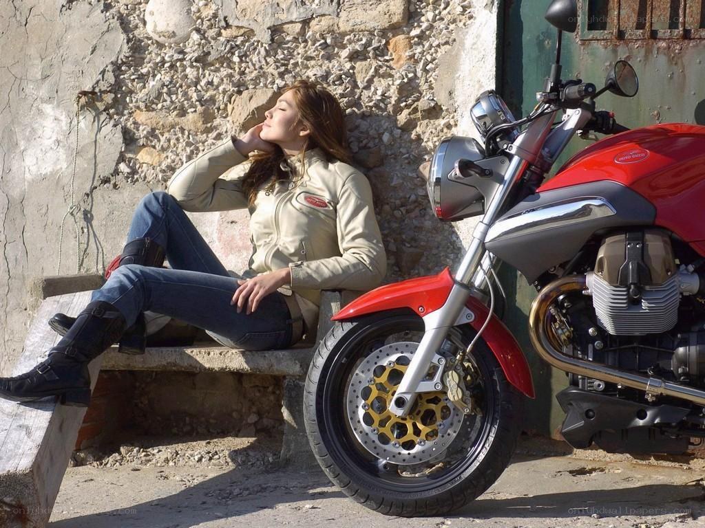Woman resting with motorcycle