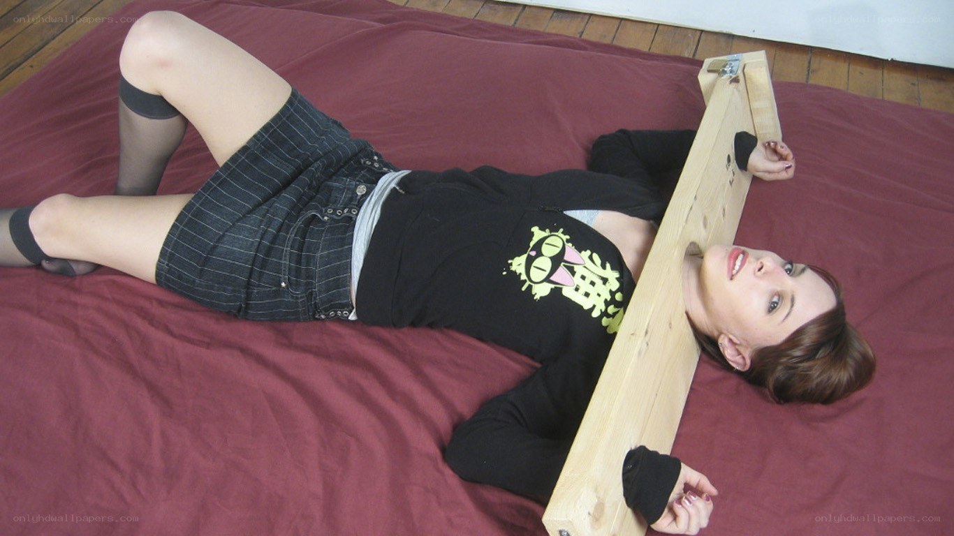 Woman restrained on bed