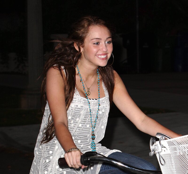 woman riding a bicycle at night