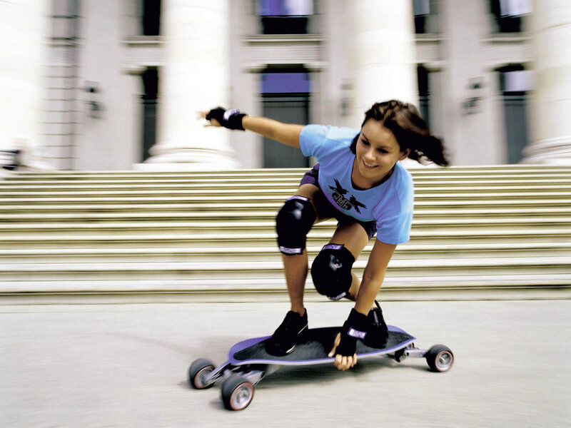 Woman riding a longboard