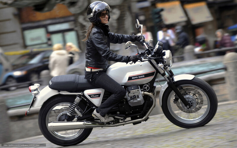 Woman riding a Moto Guzzi motorcycle
