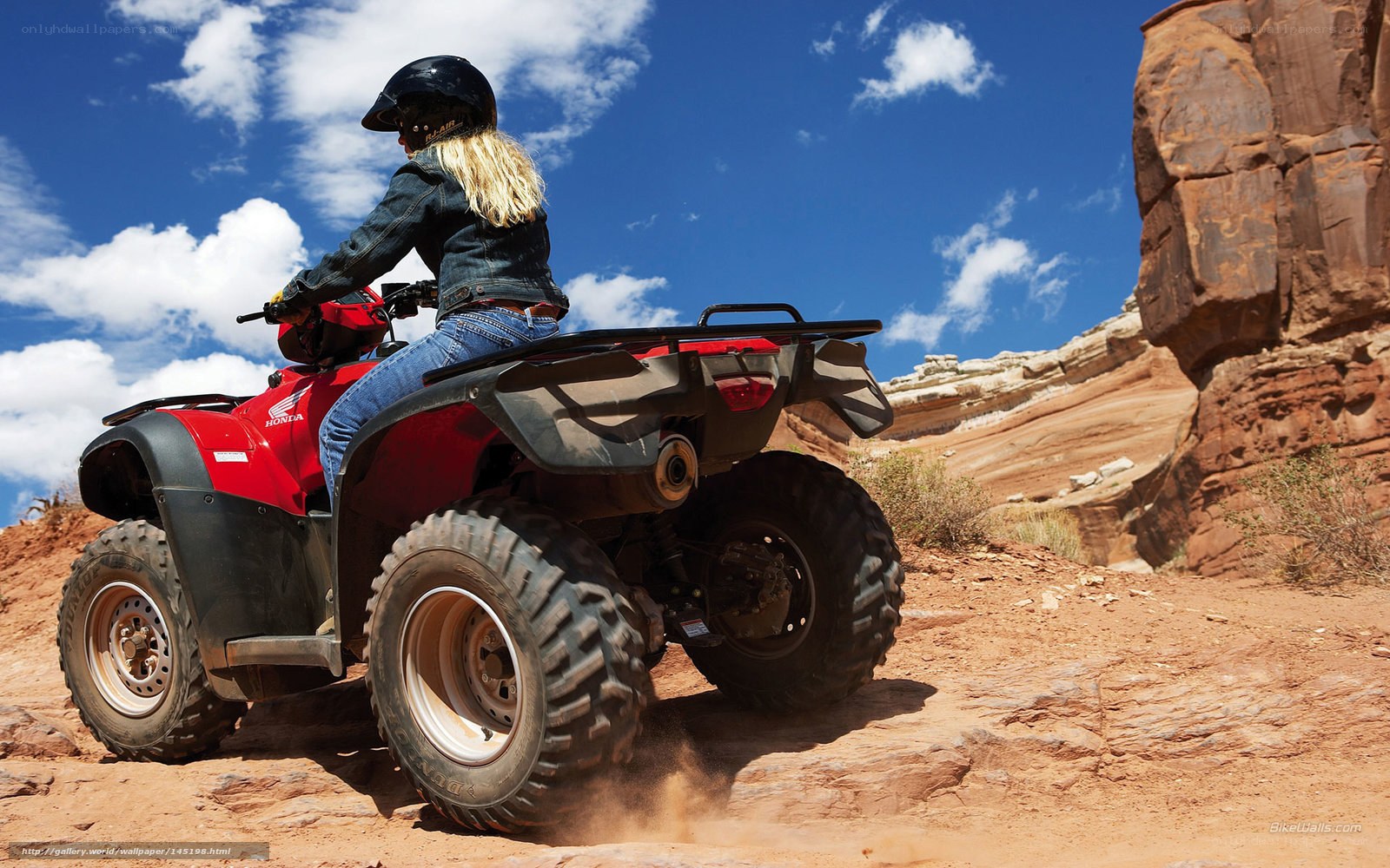 Woman riding ATV in desert