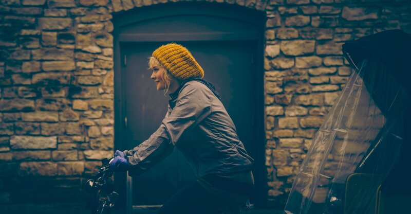 woman riding bicycle in city