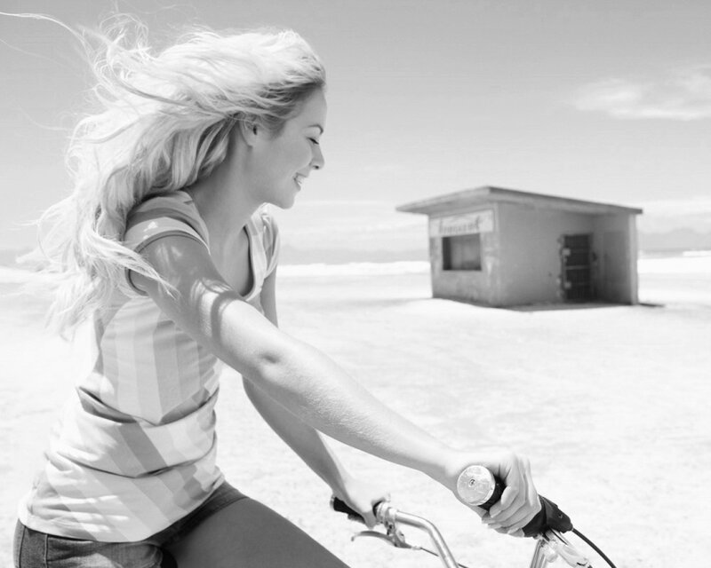 woman riding bicycle on beach