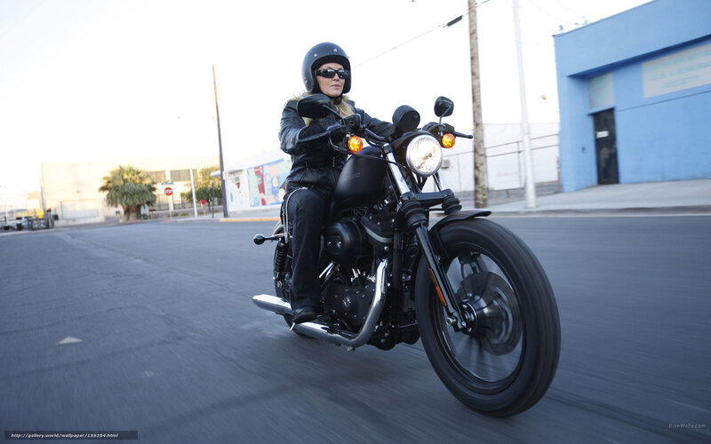 woman riding black motorcycle