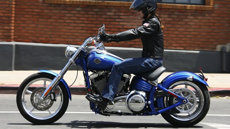 woman riding blue motorcycle