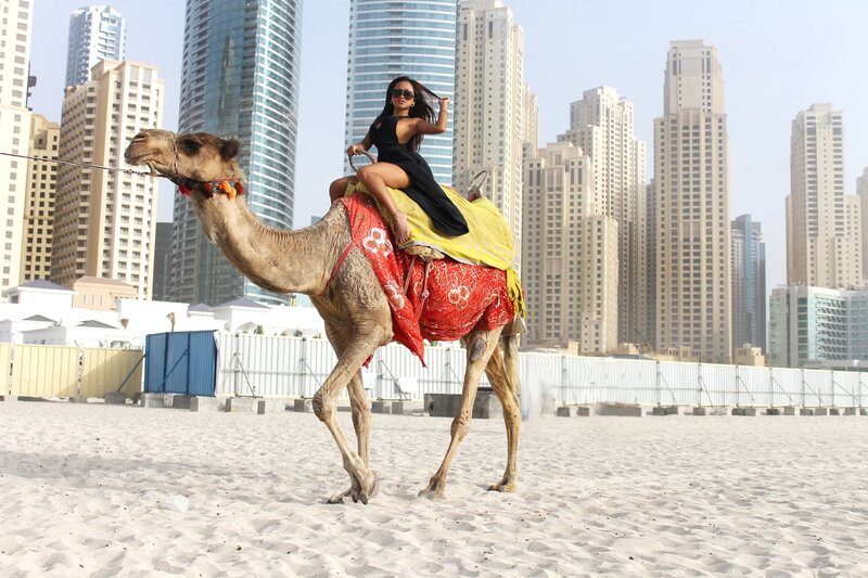 Woman riding camel in Dubai