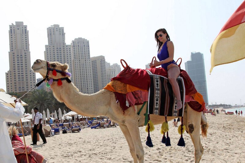 Woman Riding Camel