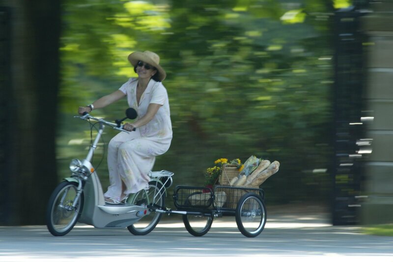 Woman riding electric bike with cart