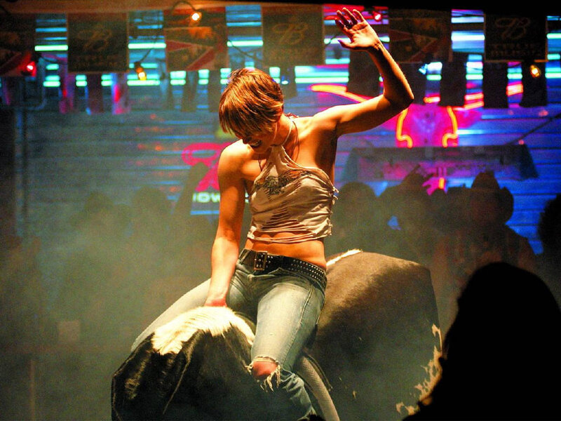 Woman riding mechanical bull