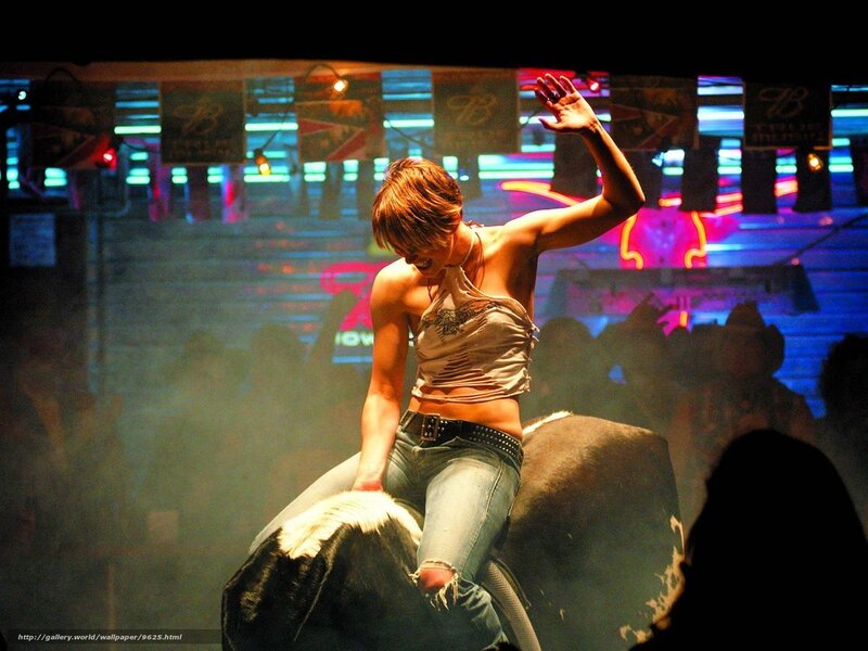 Woman riding mechanical bull